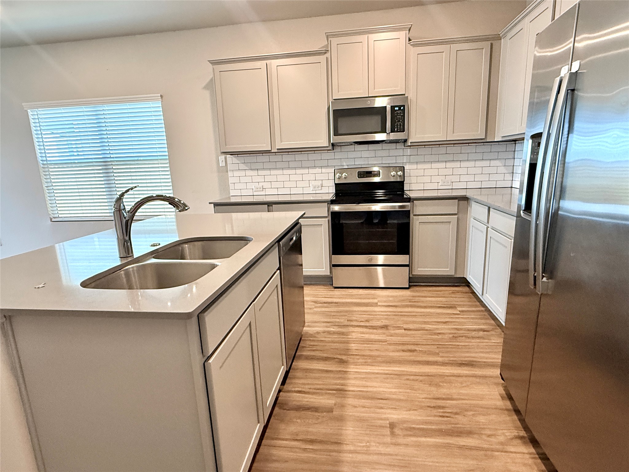 129 Perfect World Loop Jarrell, TX 76537 - Photo 6 of 31 A well-appointed kitchen features a large island with a double sink and ample counter space.