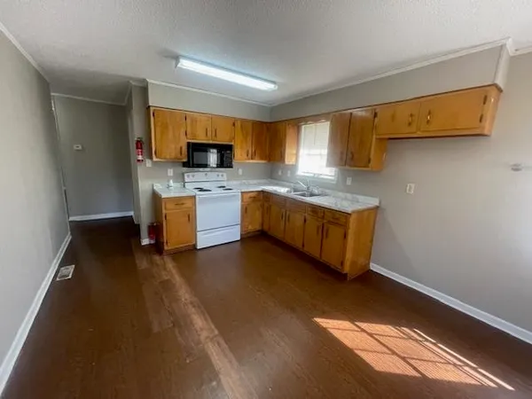 a kitchen with stainless steel appliances granite countertop a sink and a stove