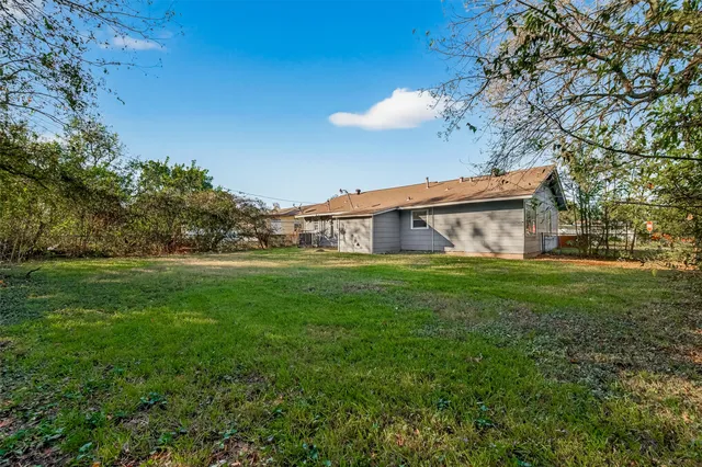 a front view of house with yard and trees