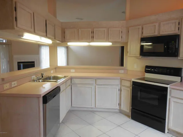 a kitchen with a sink stove and microwave