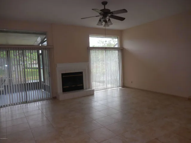 wooden floor in an empty room with a fireplace