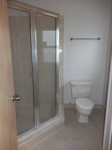 a bathroom with a toilet and a shower