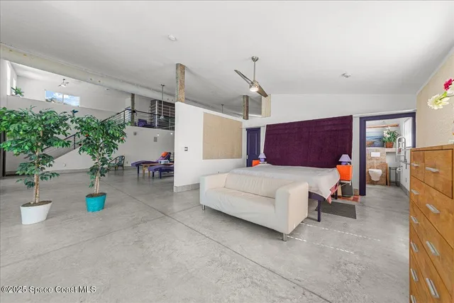 a bedroom with furniture and window