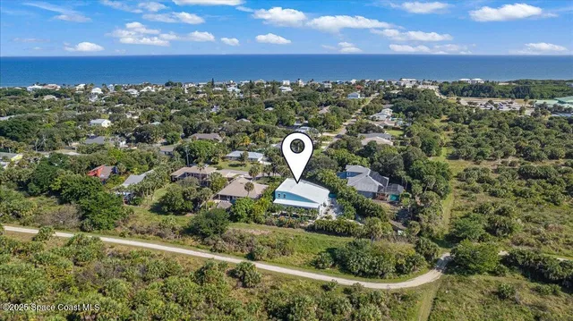 a front view of a house with plants