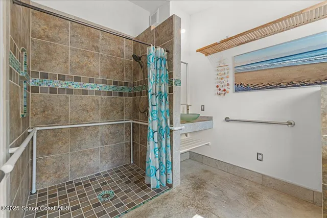 a living room with furniture pool table and windows