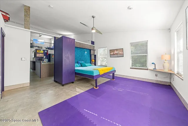 a room with pool table and windows