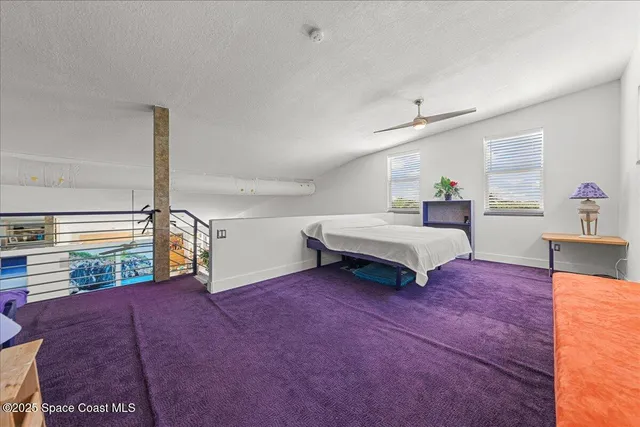 a spacious bedroom with a bed and a table