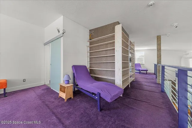 a view of a workspace with furniture and a rug