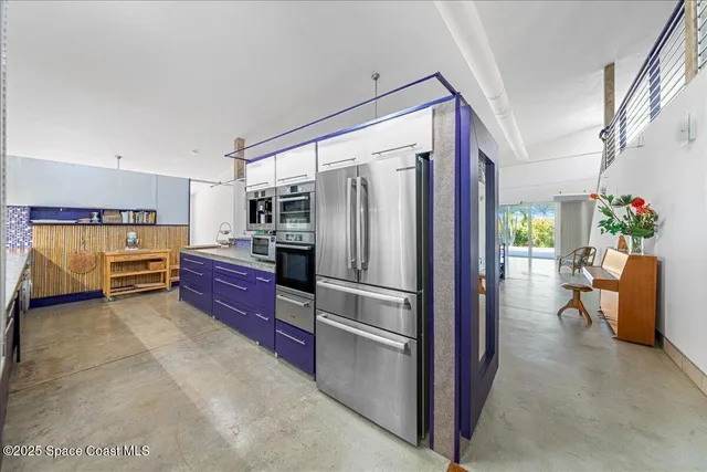 a large kitchen with stainless steel appliances granite countertop lots of counter top space