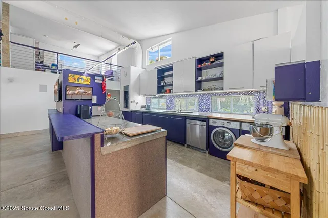 a kitchen with stainless steel appliances granite countertop a refrigerator and a stove