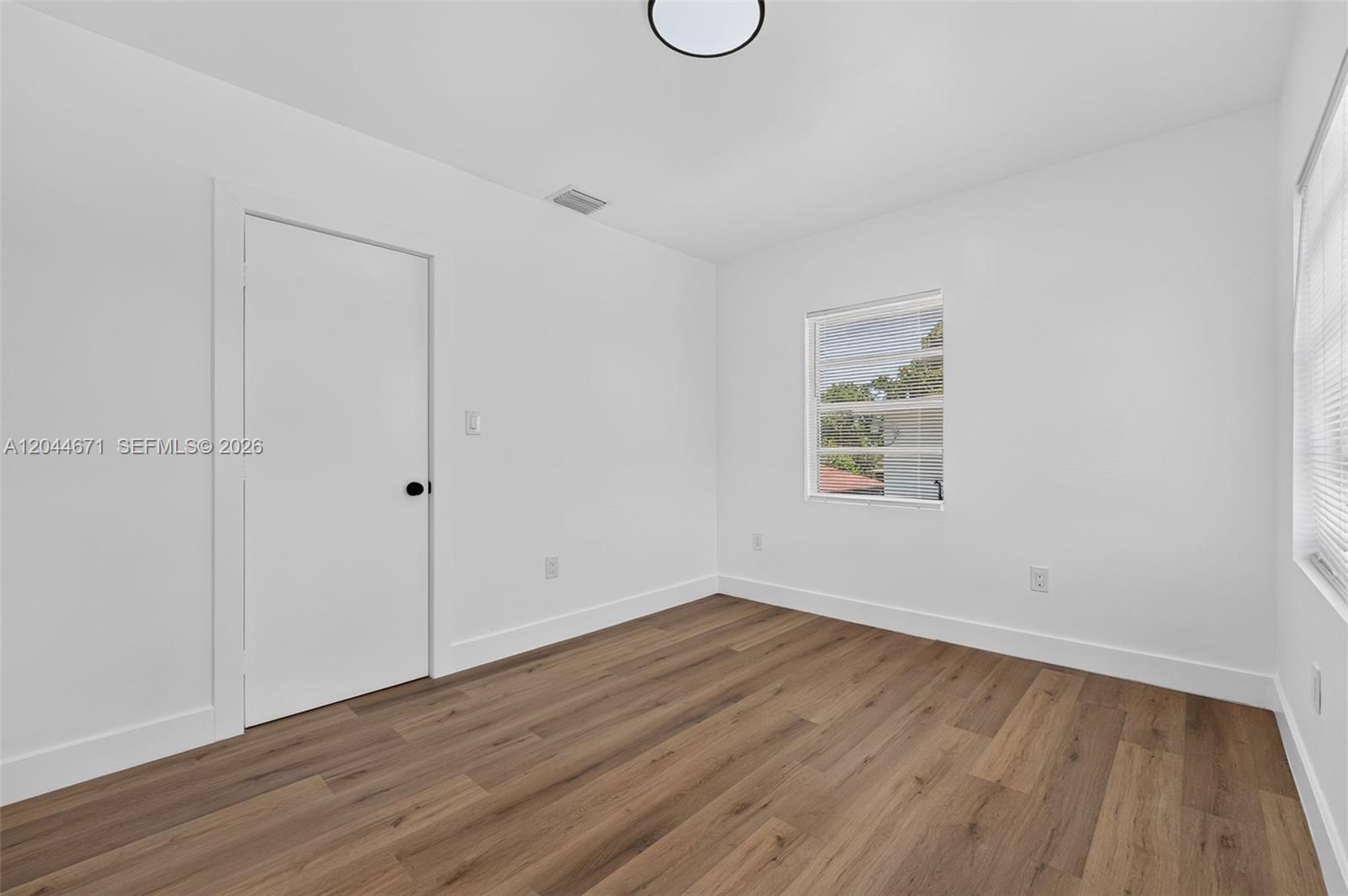 1900 Southwest 6th Street, Unit 6 Miami, FL 33135 - Photo 8 of 20 a view of a room with wooden floor and window