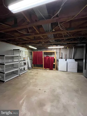 a view of empty room with white walls