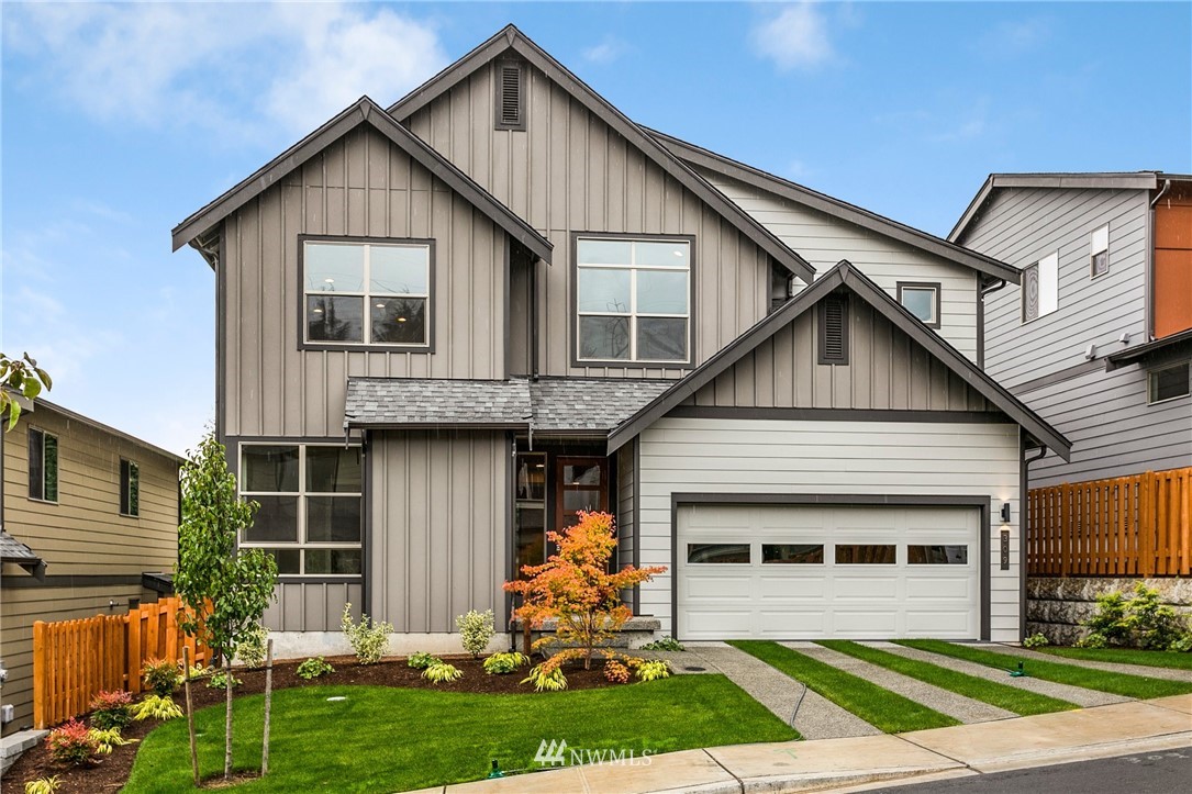 309 Southwest 3rd Court, Unit 9 Renton, WA 98057 - Photo 1 of 25 a front view of a house with a yard and potted plants