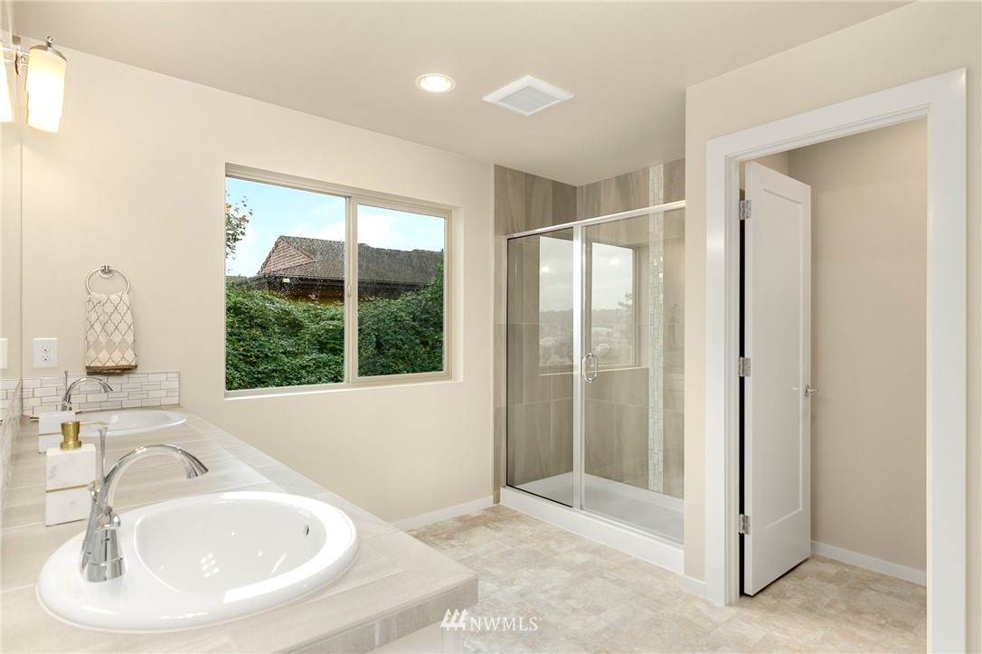 309 Southwest 3rd Court, Unit 9 Renton, WA 98057 - Photo 15 of 25 a bathroom with a sink and a large mirror