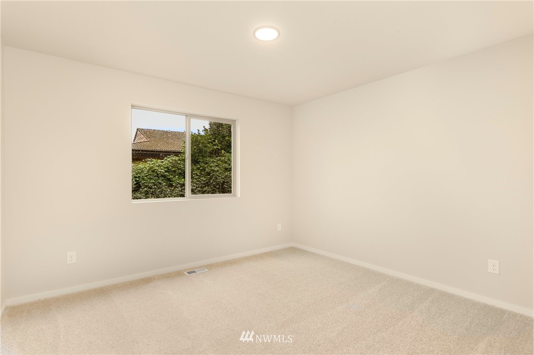 309 Southwest 3rd Court, Unit 9 Renton, WA 98057 - Photo 21 of 25 an empty room with a window