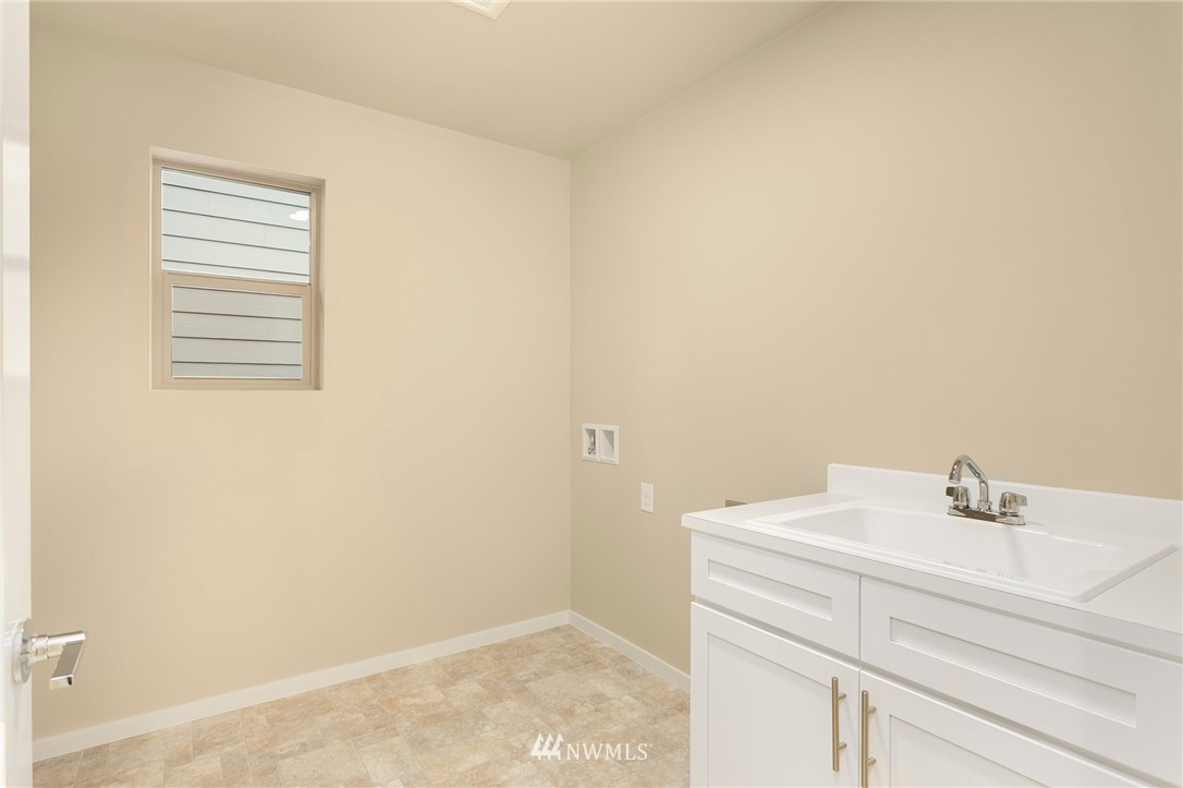 309 Southwest 3rd Court, Unit 9 Renton, WA 98057 - Photo 23 of 25 a bathroom with a sink and a vanity
