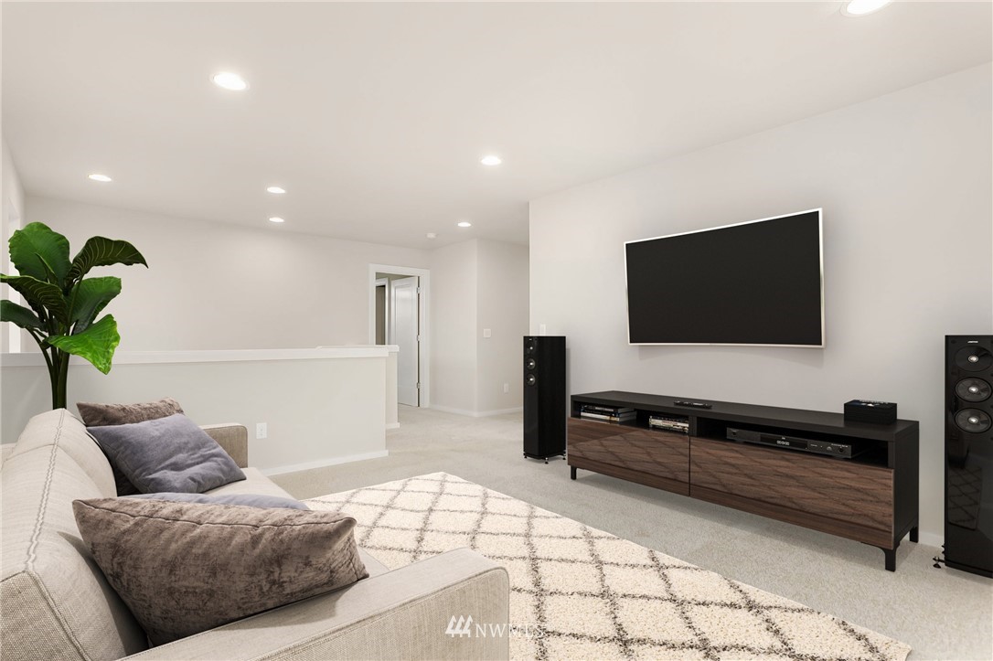 309 Southwest 3rd Court, Unit 9 Renton, WA 98057 - Photo 24 of 25 a living room with furniture and a flat screen tv