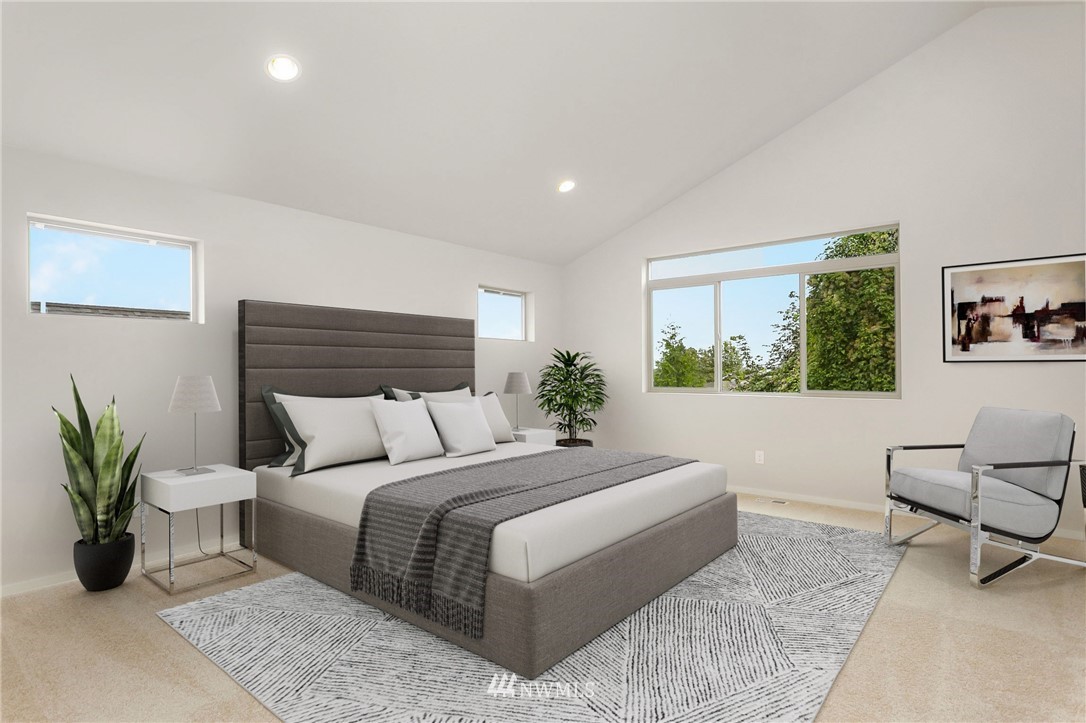 309 Southwest 3rd Court, Unit 9 Renton, WA 98057 - Photo 4 of 25 a bedroom with a large bed a couch and potted plant