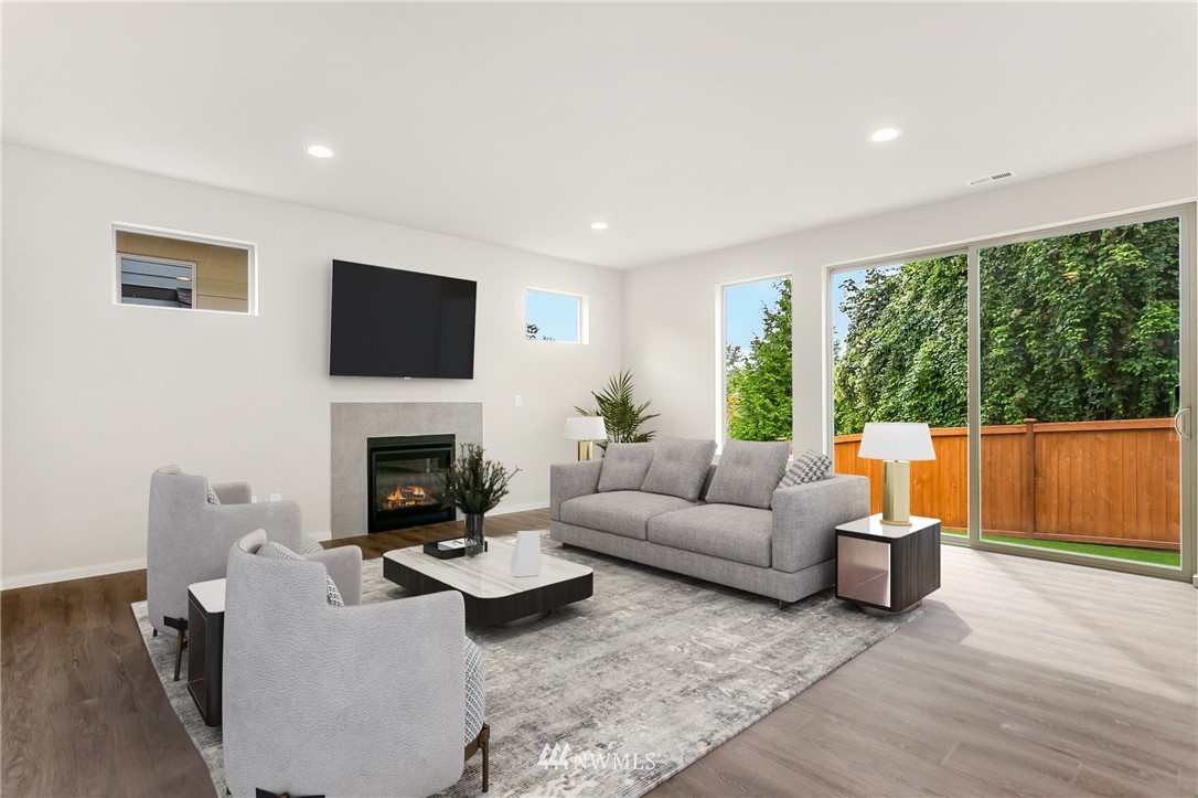309 Southwest 3rd Court, Unit 9 Renton, WA 98057 - Photo 5 of 25 a living room with furniture a fireplace and a flat screen tv