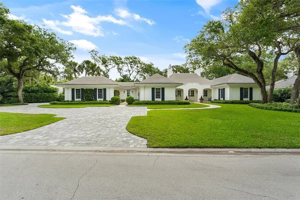 a kitchen with stainless steel appliances granite countertop a stove a sink a oven a dining table and chairs