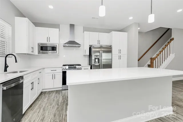 a kitchen with counter top space cabinets and stainless steel appliances