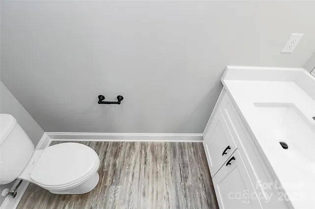 a bathroom with a toilet and a mirror