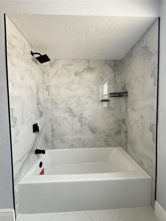 10433 Laburnum Drive Port Richey, FL 34668 - Photo 17 of 26 a bathroom with a bathtub