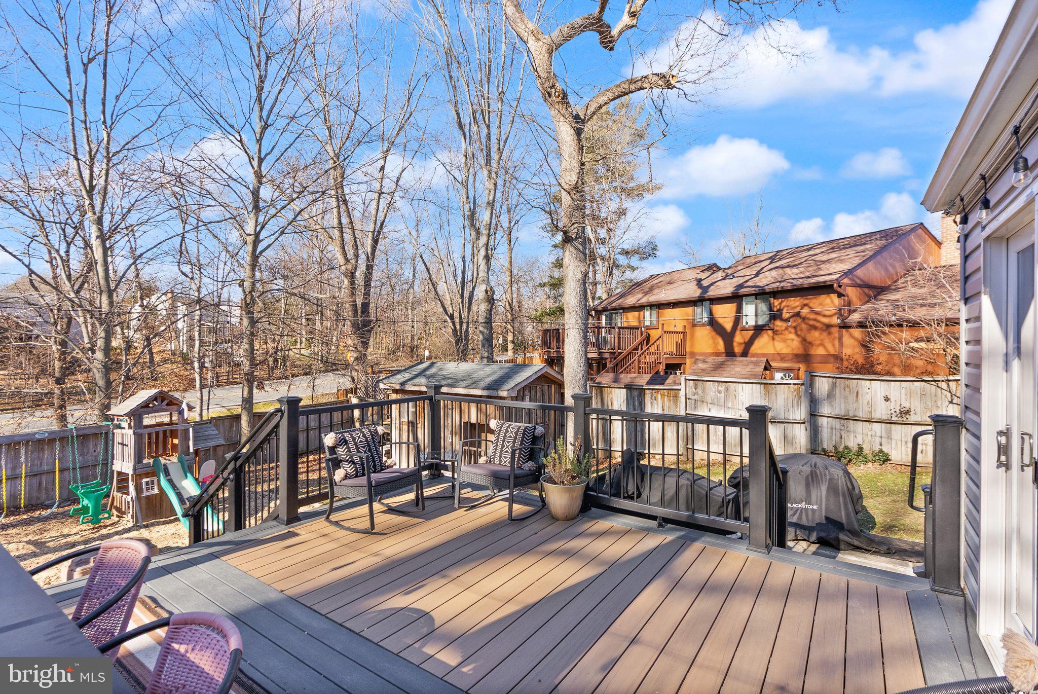 7902 Cliff Rock Court Springfield, VA 22153 - Photo 18 of 57 a view of a rooftop deck with chairs and wooden floor