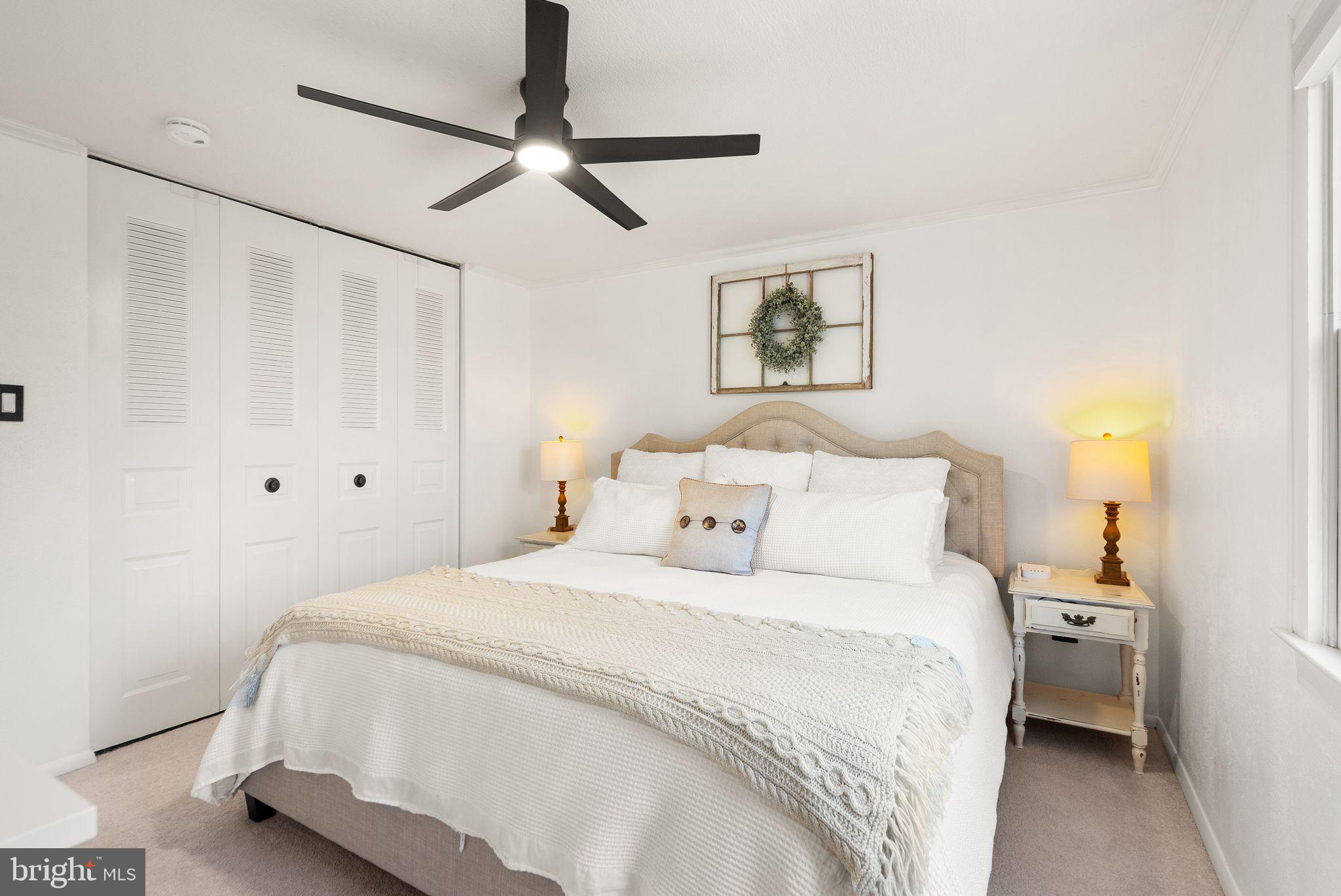 7902 Cliff Rock Court Springfield, VA 22153 - Photo 21 of 57 a bedroom with a bed and a chandelier