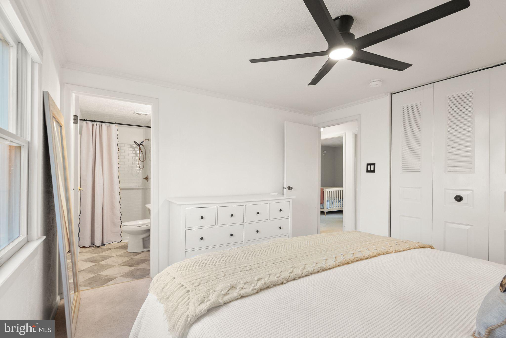 7902 Cliff Rock Court Springfield, VA 22153 - Photo 22 of 57 a spacious bedroom with a bed and a chandelier