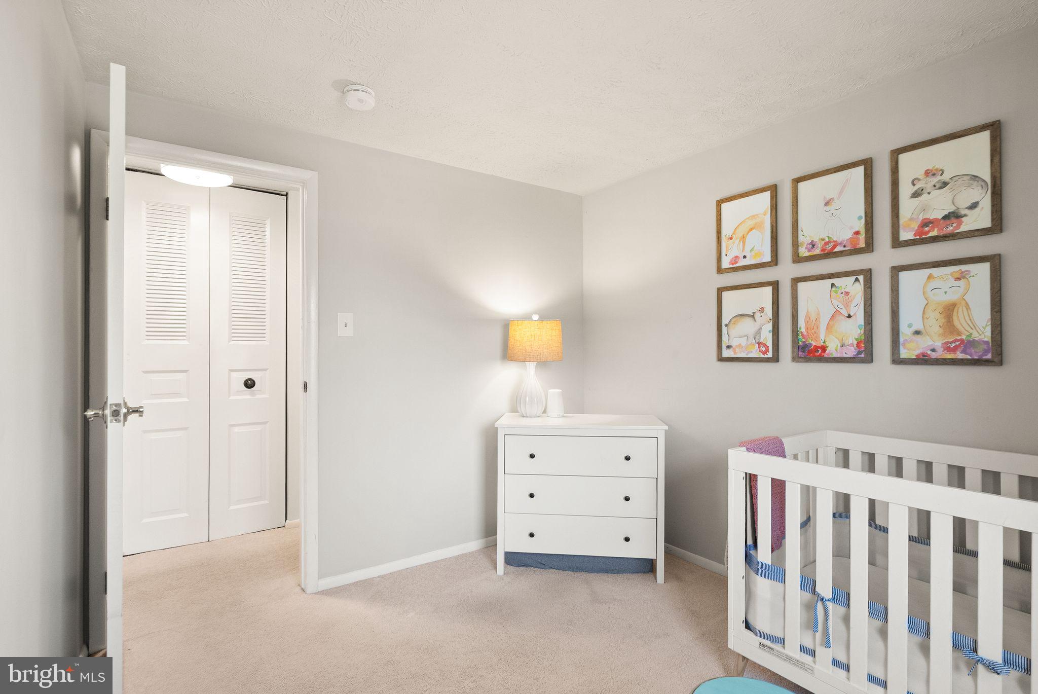 7902 Cliff Rock Court Springfield, VA 22153 - Photo 25 of 57 a view of a bedroom with baby crib and cabinet