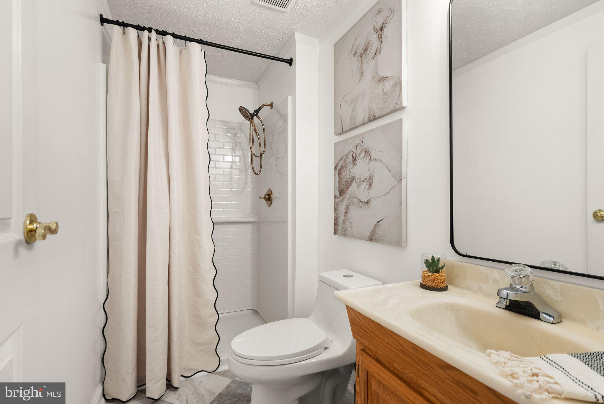 7902 Cliff Rock Court Springfield, VA 22153 - Photo 27 of 57 a bathroom with a granite countertop sink toilet and shower