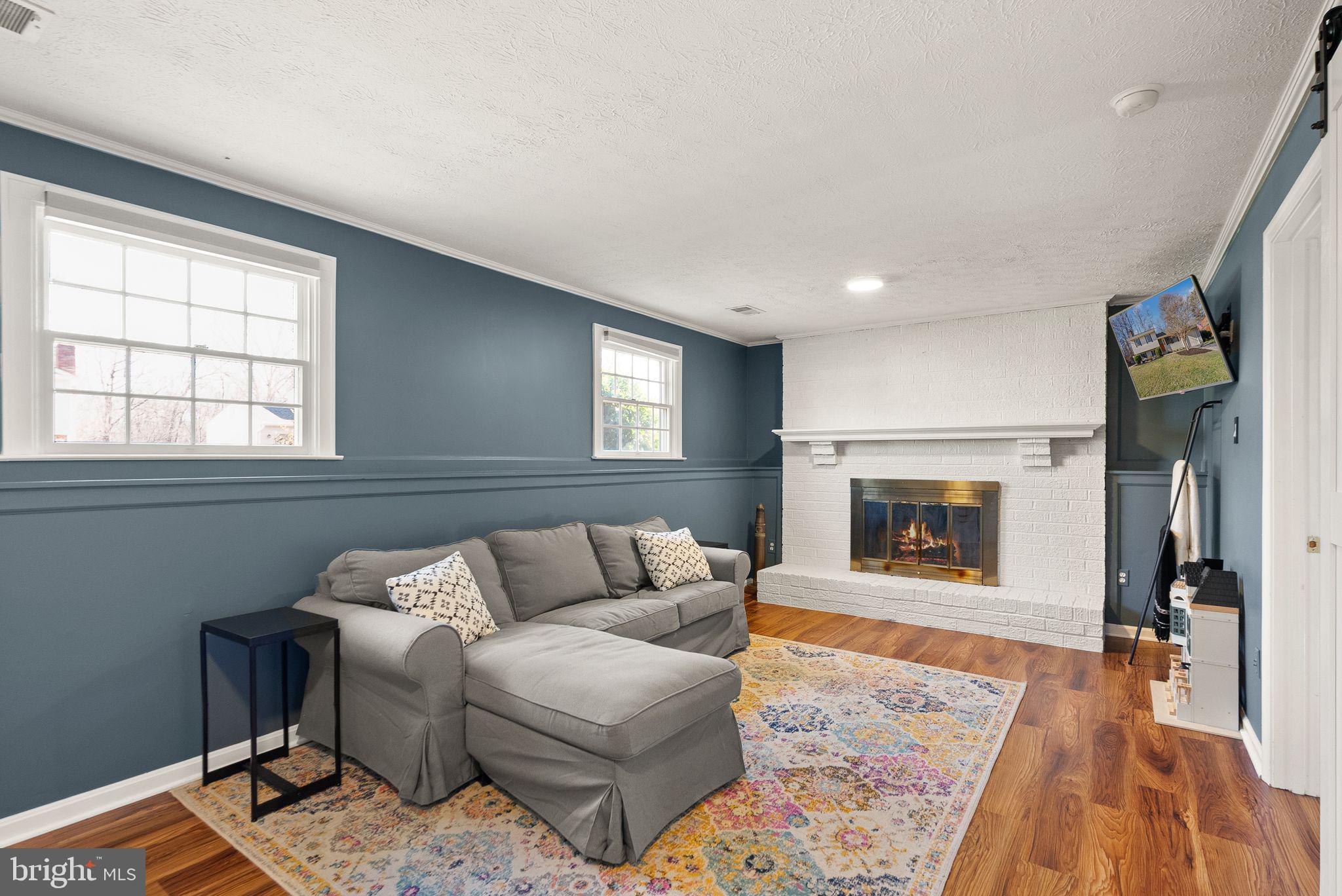 7902 Cliff Rock Court Springfield, VA 22153 - Photo 29 of 57 a living room with furniture and a fireplace