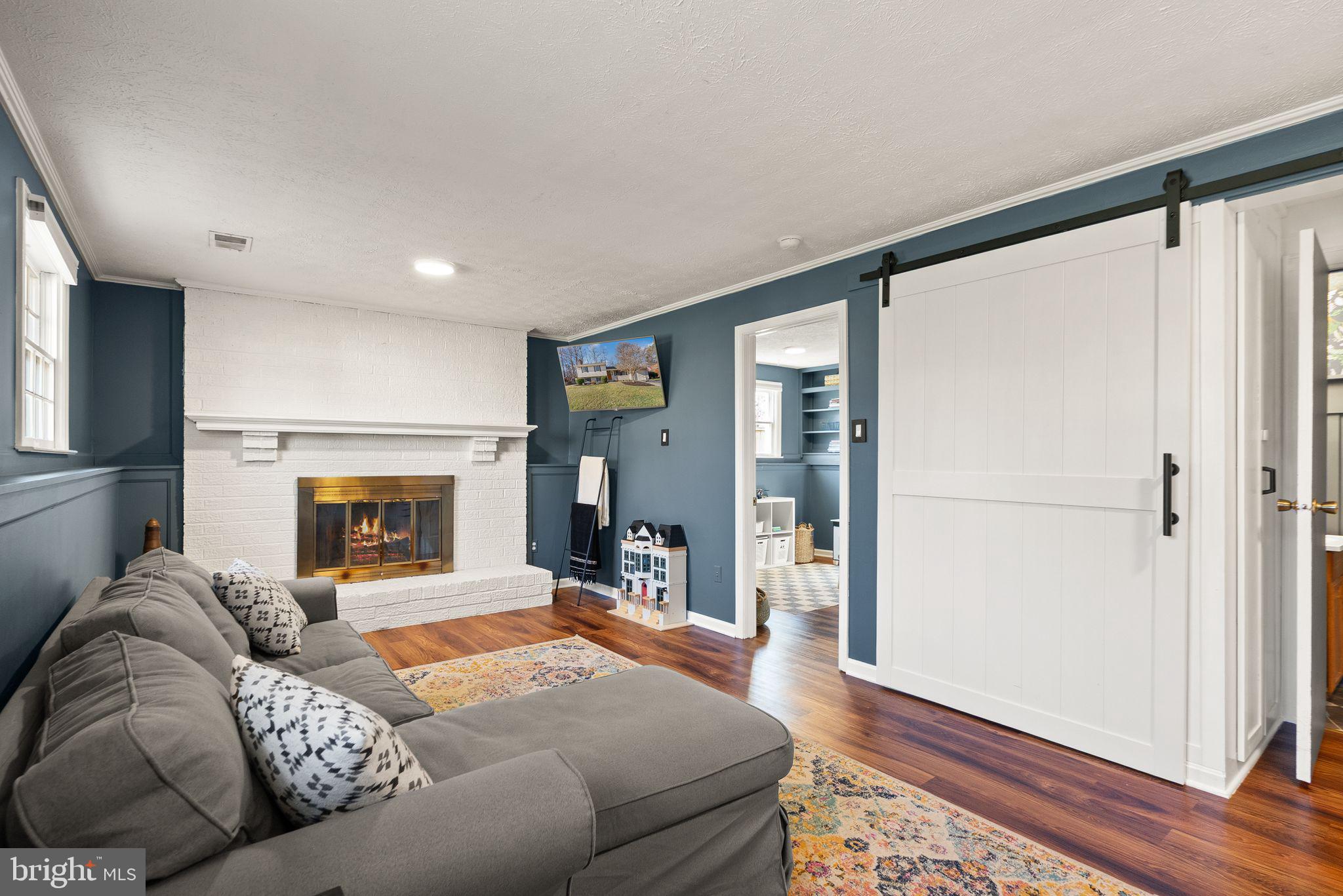 7902 Cliff Rock Court Springfield, VA 22153 - Photo 30 of 57 a spacious bedroom with a bed and a fireplace