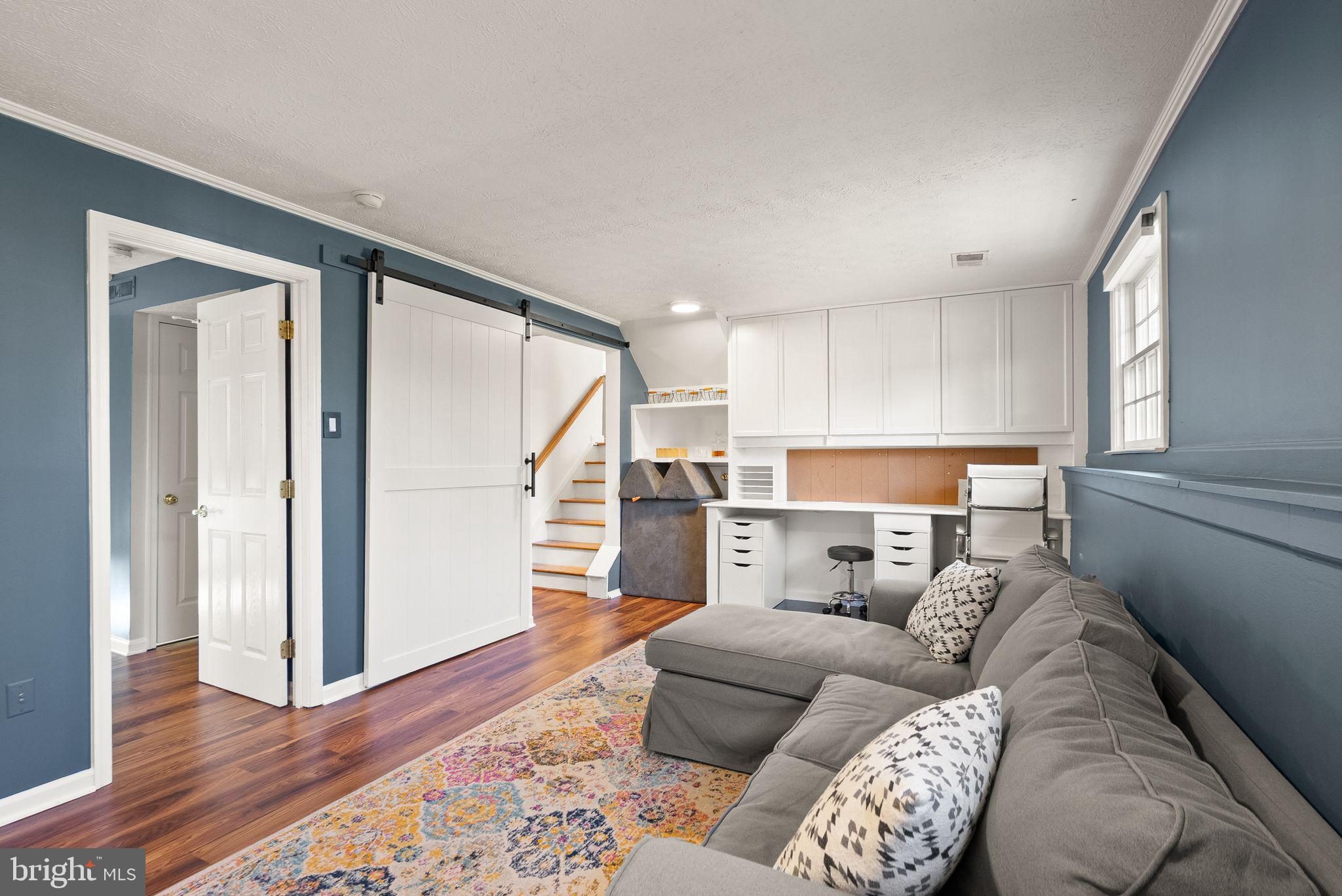 7902 Cliff Rock Court Springfield, VA 22153 - Photo 31 of 57 a living room with furniture and a wooden floor