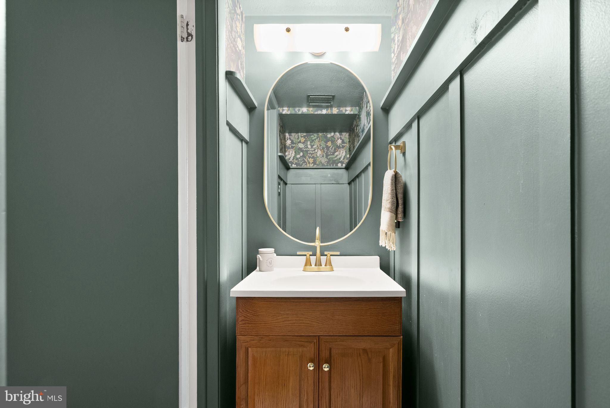 7902 Cliff Rock Court Springfield, VA 22153 - Photo 34 of 57 a bathroom with a sink and a mirror