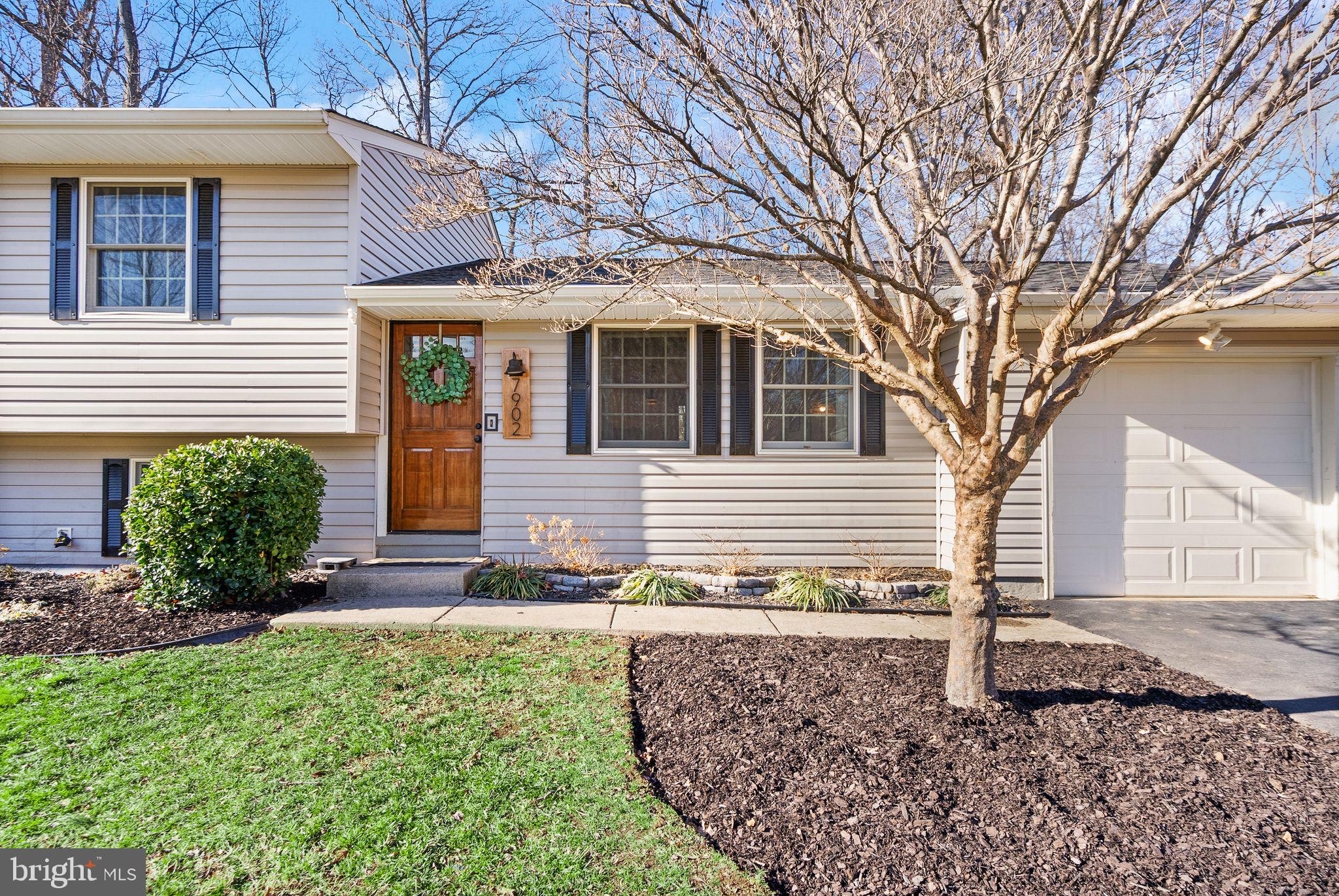 7902 Cliff Rock Court Springfield, VA 22153 - Photo 4 of 57 a front view of a house with garden