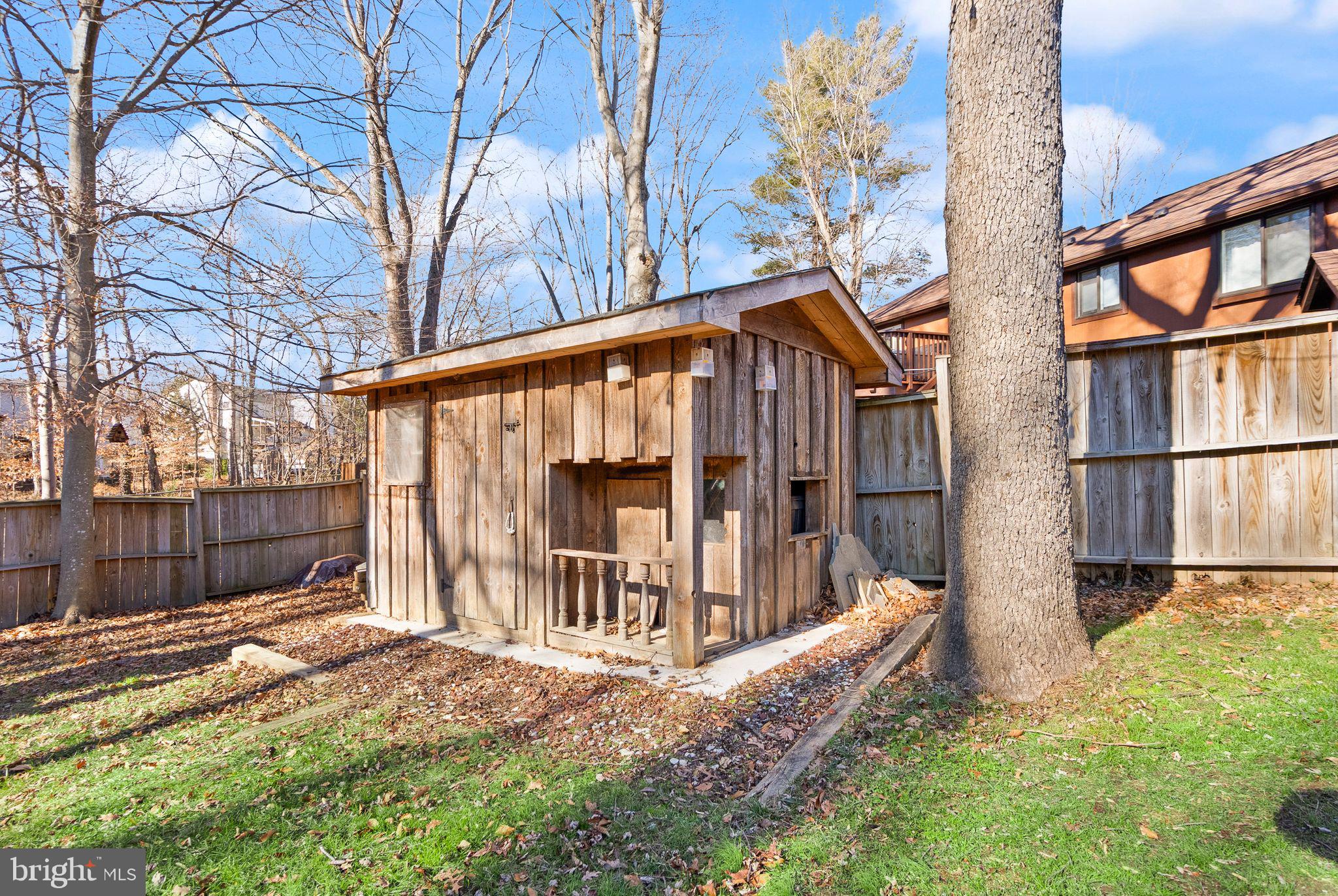 7902 Cliff Rock Court Springfield, VA 22153 - Photo 45 of 57 a view of a house with a yard and wooden fence