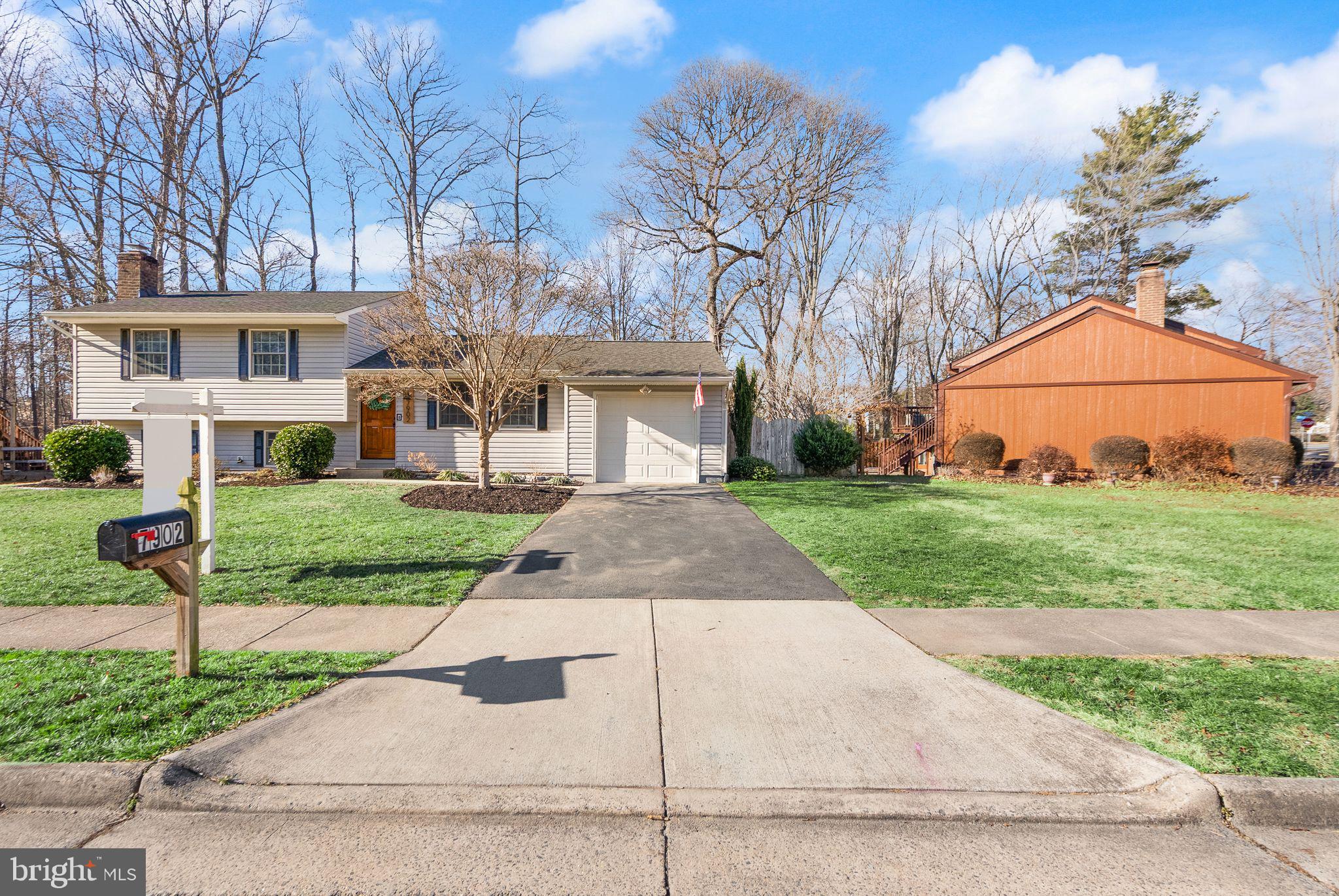 7902 Cliff Rock Court Springfield, VA 22153 - Photo 55 of 57 a front view of a house with a yard and potted plants