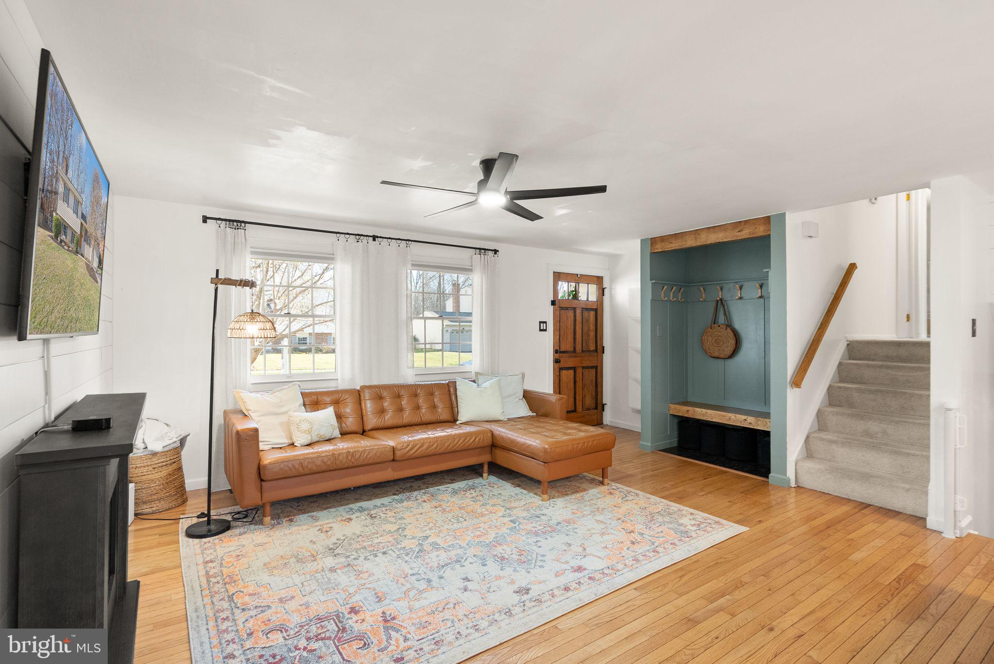 7902 Cliff Rock Court Springfield, VA 22153 - Photo 7 of 57 a living room with furniture and a flat screen tv