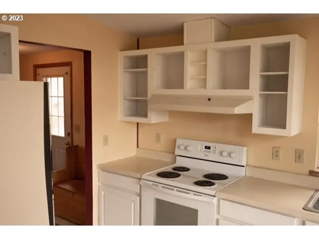 a kitchen with a stove and a microwave