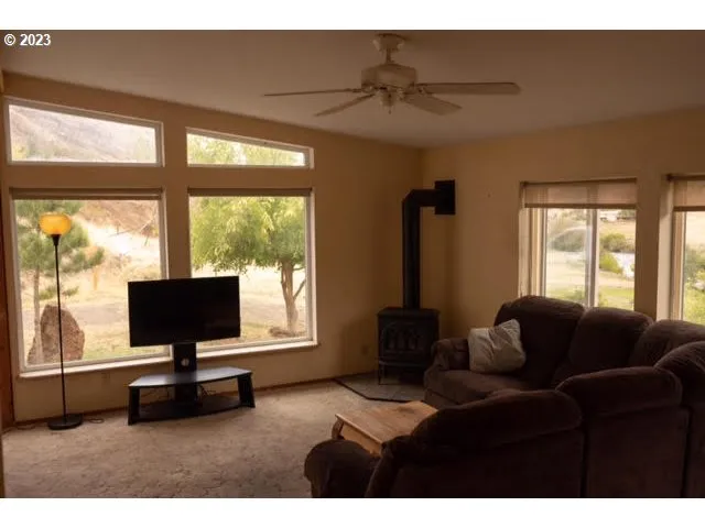 a living room with furniture tv and a large window
