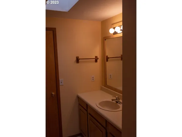 a view of a porch with a potted plant and a wall of the front