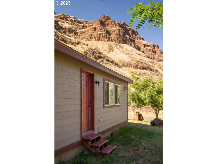 74234 Lower Imnaha Road Imnaha, OR 97842 - Photo 30 of 33 a view of a porch with a potted plant and a wall of the front