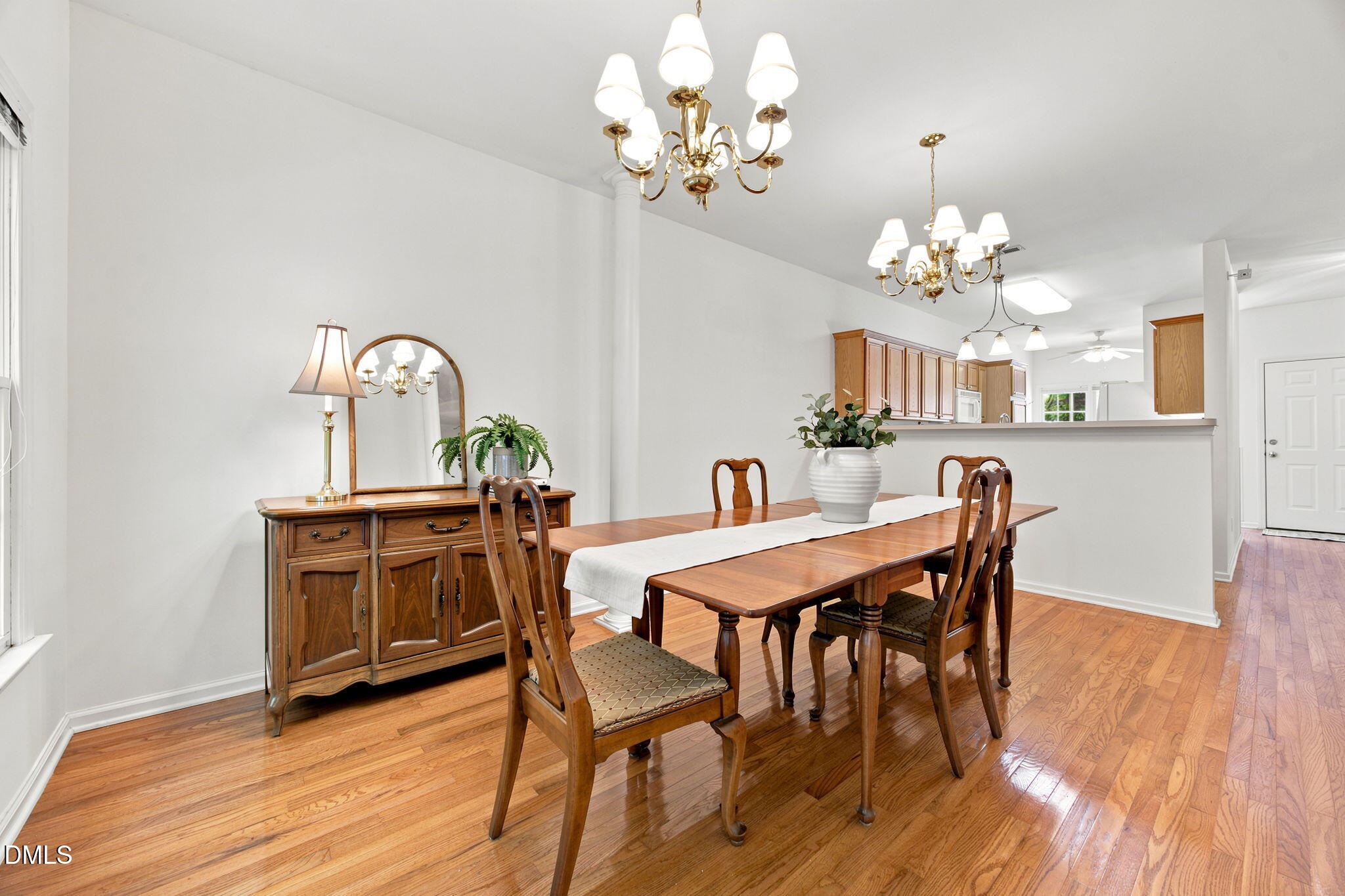 8211 Hempshire Place, Unit 104 Raleigh, NC 27613 - Photo 9 of 34 LARGE dining room open to kitchen and dining room, great for entertaining. Hardwood flooring extending throughout, complemented by a decorative chandelier