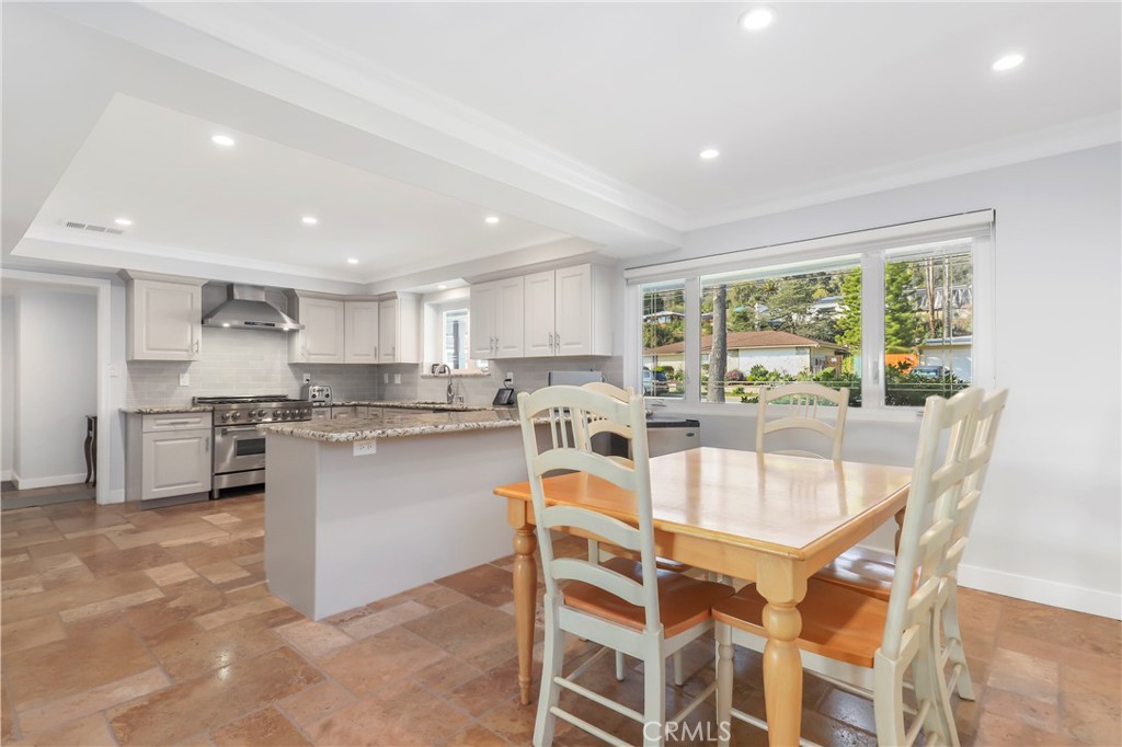 3810 Startouch Drive Pasadena, CA 91107 - Photo 14 of 53 a kitchen with a table chairs refrigerator and cabinets