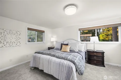 a bedroom with a bed dresser and a window