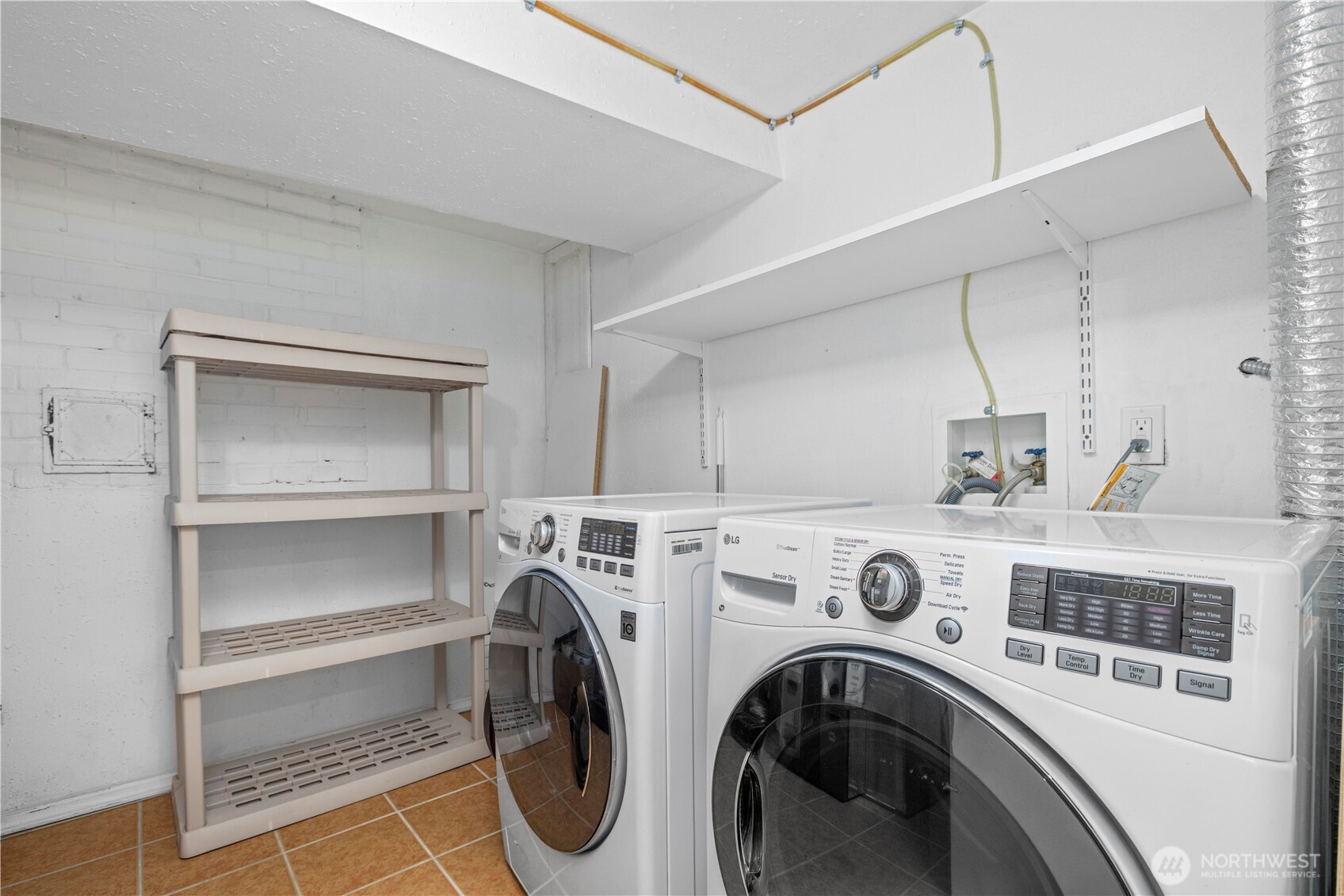 15245 Fremont Avenue North Shoreline, WA 98133 - Photo 19 of 28 a view of washer and dryer with kitchen in the background