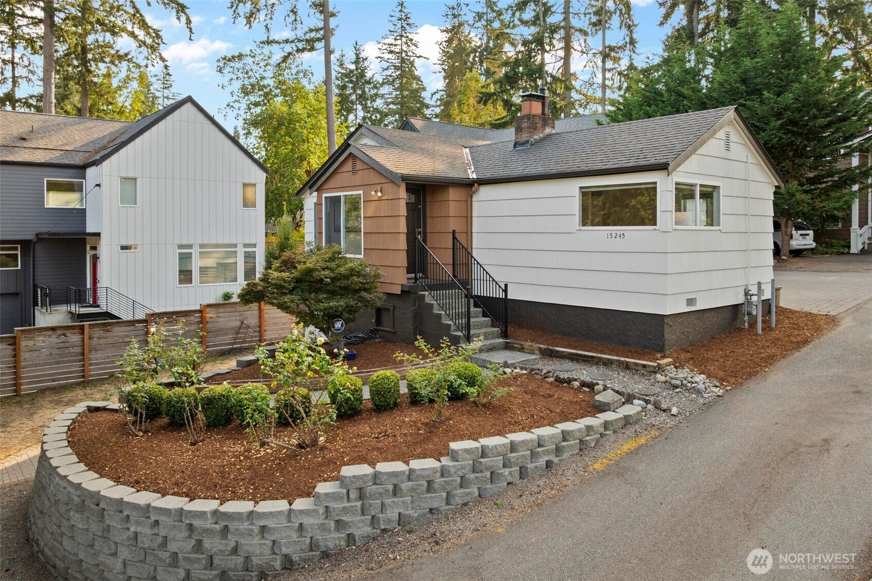 15245 Fremont Avenue North Shoreline, WA 98133 - Photo 2 of 28 a view of a house with backyard and sitting area