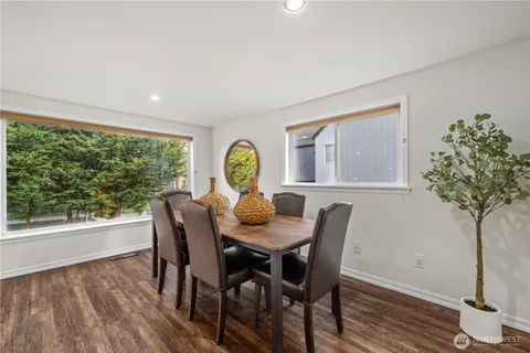 a view of a dining room with furniture window and wooden floor